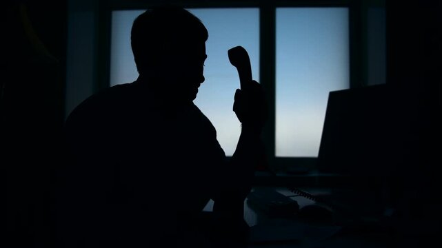 Tranquil Customer Support Staff Addresses Complaints With Focus During Nighttime Work Shift . Media