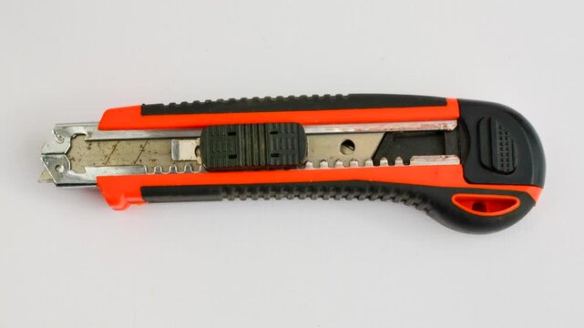 Sharp utility knife on a clear surface, ready for precise cuts for creative projects. Close-up of a stylus on a light background, an essential tool for detailed work.