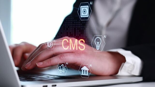 Working on a computer with CMS and AI icons during a business meeting in an office setting.