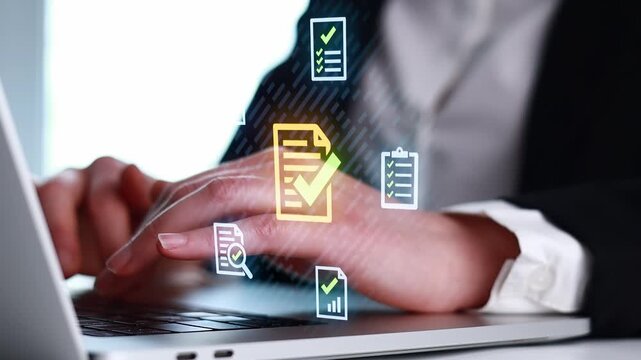 Typing on a laptop with digital checkmarks and documents shown on the screen, likely during a work or study session.
