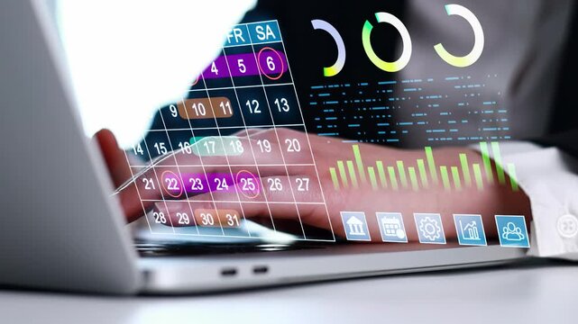 Business person uses laptop to manage data and schedule tasks with digital tools in an office setting during daytime.