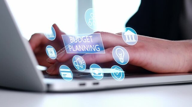 Planning a budget on a laptop with digital icons showing financial activities at a workspace in daylight.