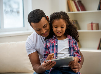 Fototapeta premium Father and daughter using tablet together.