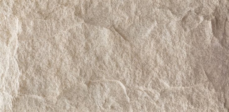 A close-up view of a rough textured stone surface