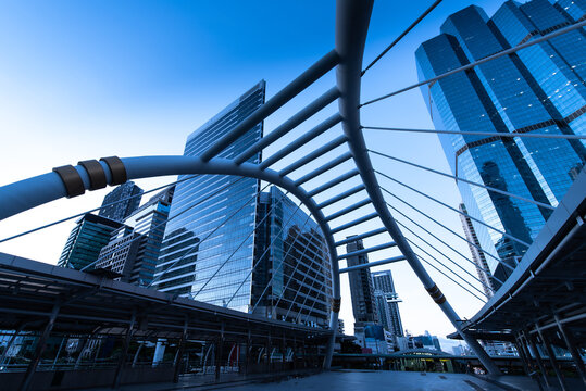 Modern structure bridge shape and building at train station in Bangkok, Thailand. Blue tone
