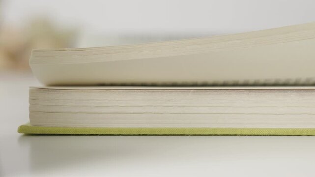 Slowly flipping book pages detail