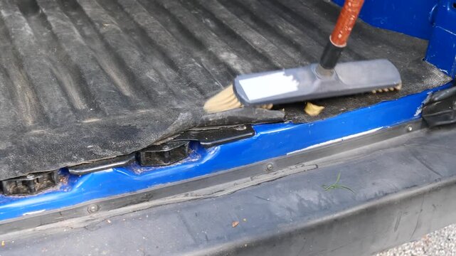Sweeping the floor of a small van after a day's work