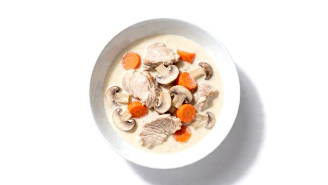 creamy french blanquette de veau stew with carrots and mushrooms in white bowl