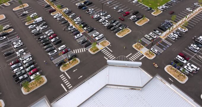 Aerial view of crowded shopping mall parking lot in Florida, filled with vehicles and busy traffic. Consumer activity, retail demand and urban commercial lifestyle.