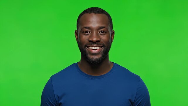 Portrait of Serenity: An affable man with a radiant smile graces the lens, his face mirroring contentment against a vibrant green backdrop, capturing a moment of genuine warmth.