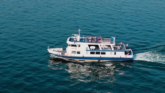 Passenger ferry cruising between towns on Lake Garda, water transport carrying people in Italy