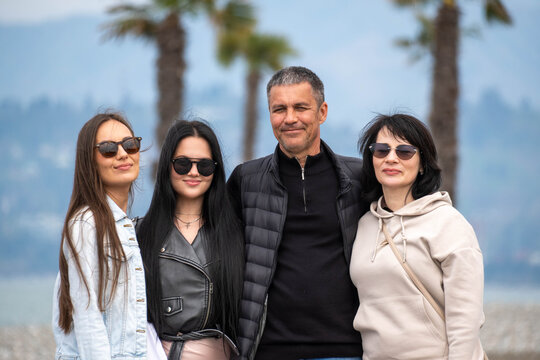 portrait of a happy family, tropical sea background