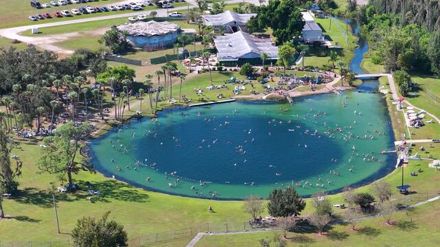 Natural sinkhole filled with clear blue mineral water, used for swimming and spa-like relaxation, symbolizing health, healing and mindful travel in the southern USA.