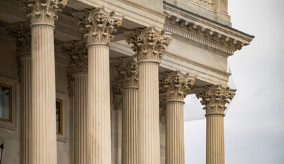 Fototapeta premium Columns stone architectural perspective symmetry. Columns marble fluted repetition. Columns decorative capitals carved detail. Columns classical heritage design.