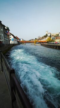 Static shot of rushing Reuss river water with Spreuer Bridge and Musegg Wall, Lucerne, Switzerland