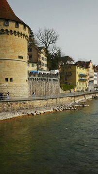 Static shot of the historic Noelli Tower and Reuss river waterfront in Lucerne, Switzerland