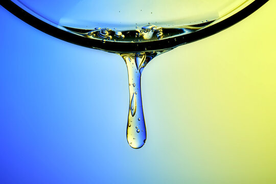 Clear hyaluronic serum dripping, showing hydration technology