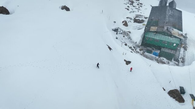 Drone orbit revealing snow-covered Phase 2 Gondola station in Gulmarg.