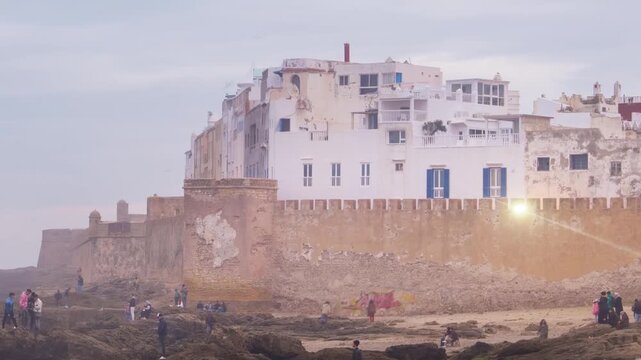 Essaouira, Morocco. Sunset view of Essaouira is a city and port on the Atlantic coast in Morocco, North Africa. Time-lapse with tourists