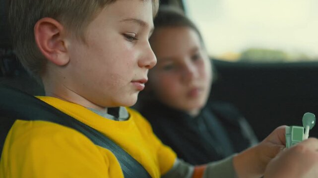 Children play with toys in a car during a trip to a park on a sunny day