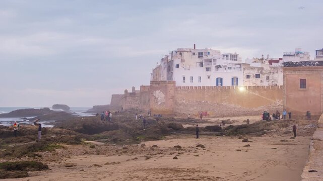 Essaouira, Morocco. Sunset view of Essaouira is a city and port on the Atlantic coast in Morocco, North Africa. Time-lapse with tourists