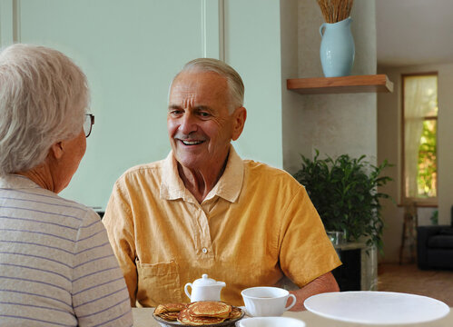 elderly couple at home at breakfasgt table