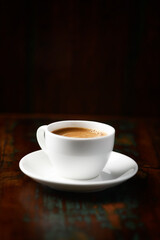 Obraz premium Cup of coffee on rustic wooden background. Soft focus. Copy space