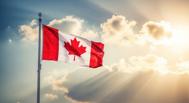 Canadian flag waving in the wind against a sunny sky