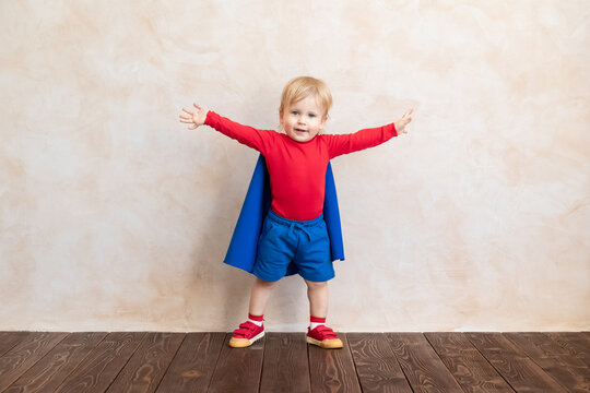 Little boy dressed as a superhero having fun at home
