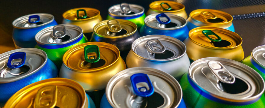 Colorful used metal beverage cans close-up. Concept of collection, recycling, and reuse of packaging