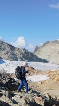 Adventurous Hiker Descending Rocky Terrain Towards a Glacier in British Columbia, Canada