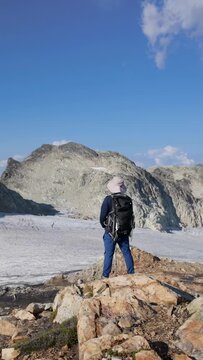 Hiker Admiring Majestic Glacier and Mountain Landscape in British Columbia, Canada on a Sunny Day