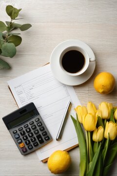 Portrait tidy seasonal finance still life with blank forms, calculator, coffee cup, lemons, and tuli