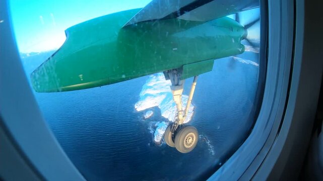 Aerial view from a small twin-propeller plane approaching Leknes Airport in the Lofoten Islands, Norway. This cinematic Arctic approach captures the raw beauty of northern Norway in winter.