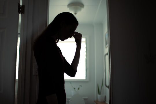 Depressed Woman Standing in Bathroom Silhouette Emotional Stress Concept

