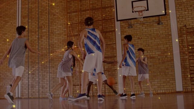 School players dribbling ball toward hoop on court, scrambling for possession, gold dust appearing