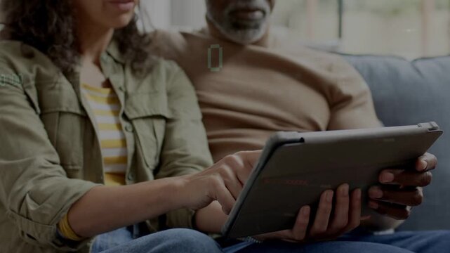 Woman placing tablet while man holding, woman tapping or swiping, timecode syncing, pair browsing te