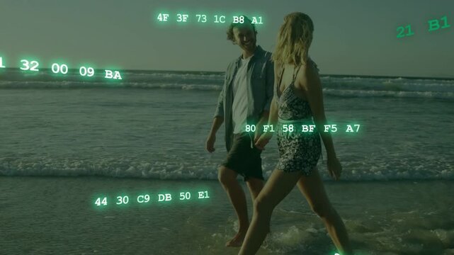 Couple walking on beach wading into surf and activating green hex code overlays showing tech data