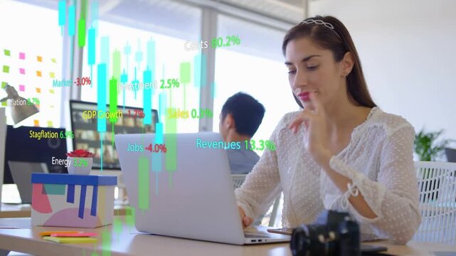 Woman at laptop getting market feed, reviewing, typing while moving candlestick charts overlay desk