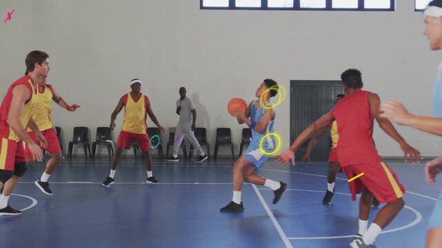 Sports light-blue ballhandler bringing ball into key, driving to hoop to score, defenders closing