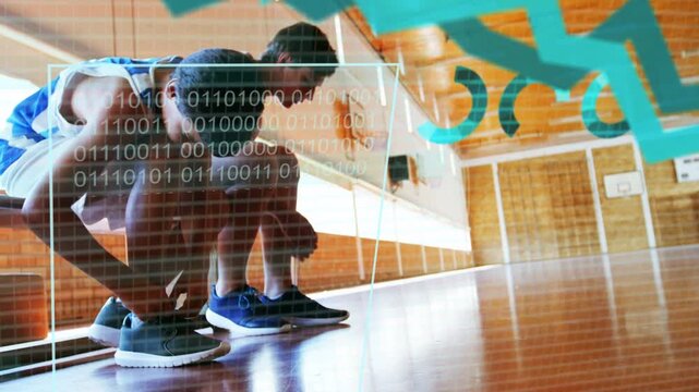 Two boys crouching tying laces in school gym, starting sports analytics overlaying boys and charts