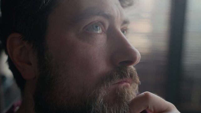 Close up of bearded middle aged Caucasian man overthinking and blinking his eyes, concepts of depression and frustration, burnout at work