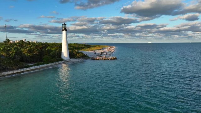 Aerial film recording a lighthouse on the beach coast in the afternoon