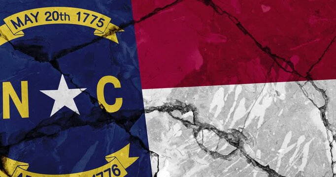 A panning video of a cracked wall with The North Carolina state flag of the United States of America