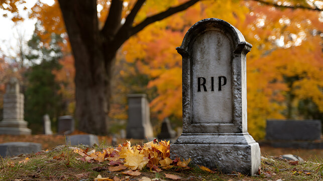 Stone grave marker with RIP on an arched headstone in cemetery during autumn, vibrant fall leaves and trees in background, somber mood