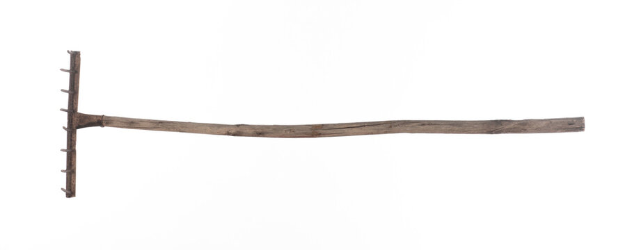 Old garden rake isolated on white background