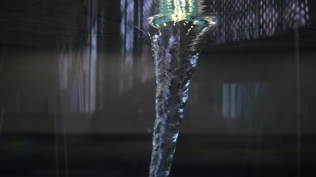 Powerful water vortex spinning rapidly, forming a tornado like funnel inside a transparent container, demonstrating concepts of fluid dynamics, energy, and centrifugal force with mesmerizing motion