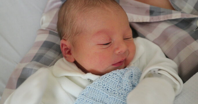 Mother and newborn baby after birth, real life care and affection
