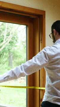  A Man or Contractor Measures a Large Sliding Door - Angle 1 - Vertical