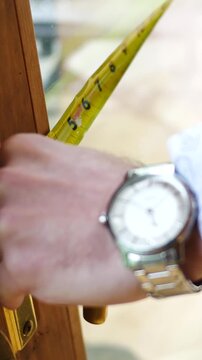 A Man or Contractor Measures a Large Sliding Door - Angle 2 - Vertical
